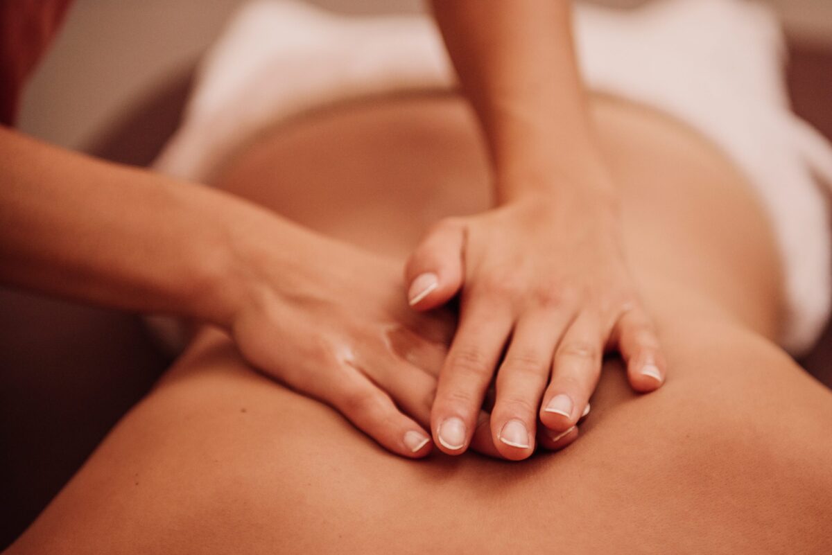 Woman hands massaging a person's back